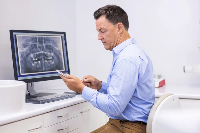 dentist with mobile 1384x923